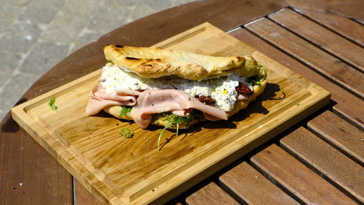 Pizza sandwich with mortadella, burrata and pesto