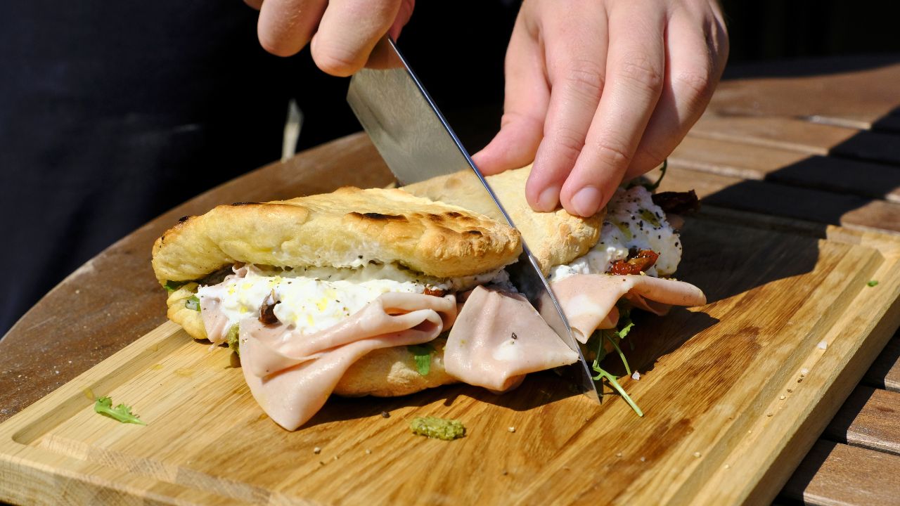 Pizzasandwich skæres over på skærebræt 